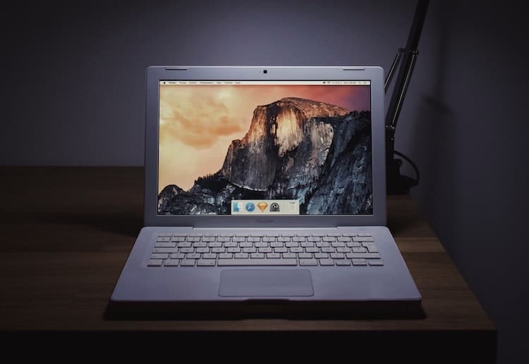 old apple laptop on desk